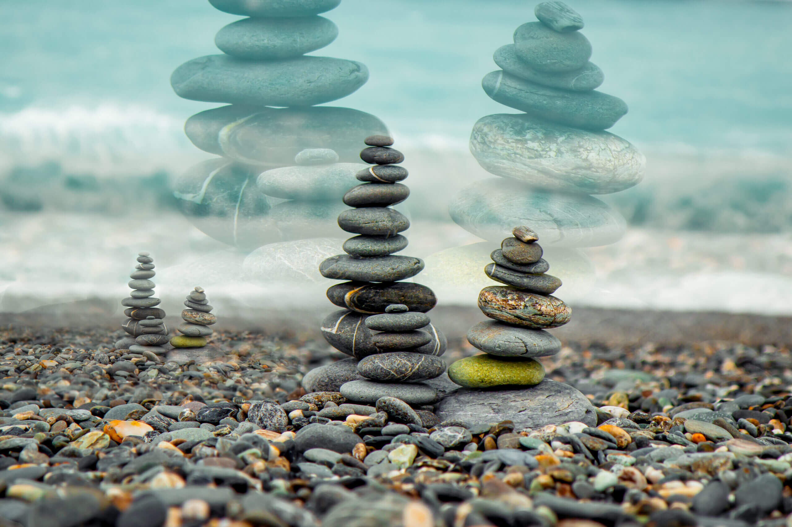 rocks stack A pile of rocks sitting on top of a beach.