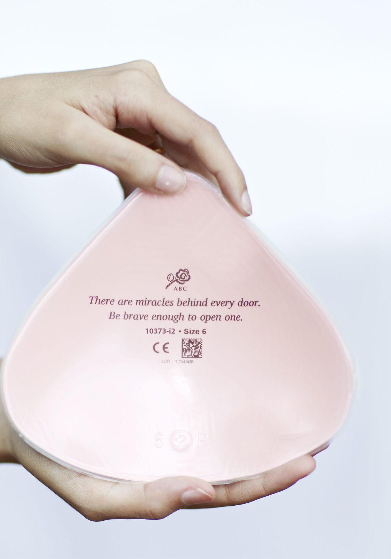 A person holding onto a pink bowl with the words " you are an object in nothingness than it does to make someone happy ".