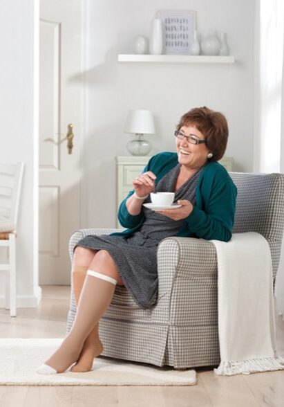 A woman sitting in a chair eating something.