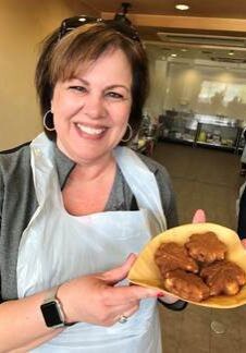 A woman holding a plate of food in her hands.