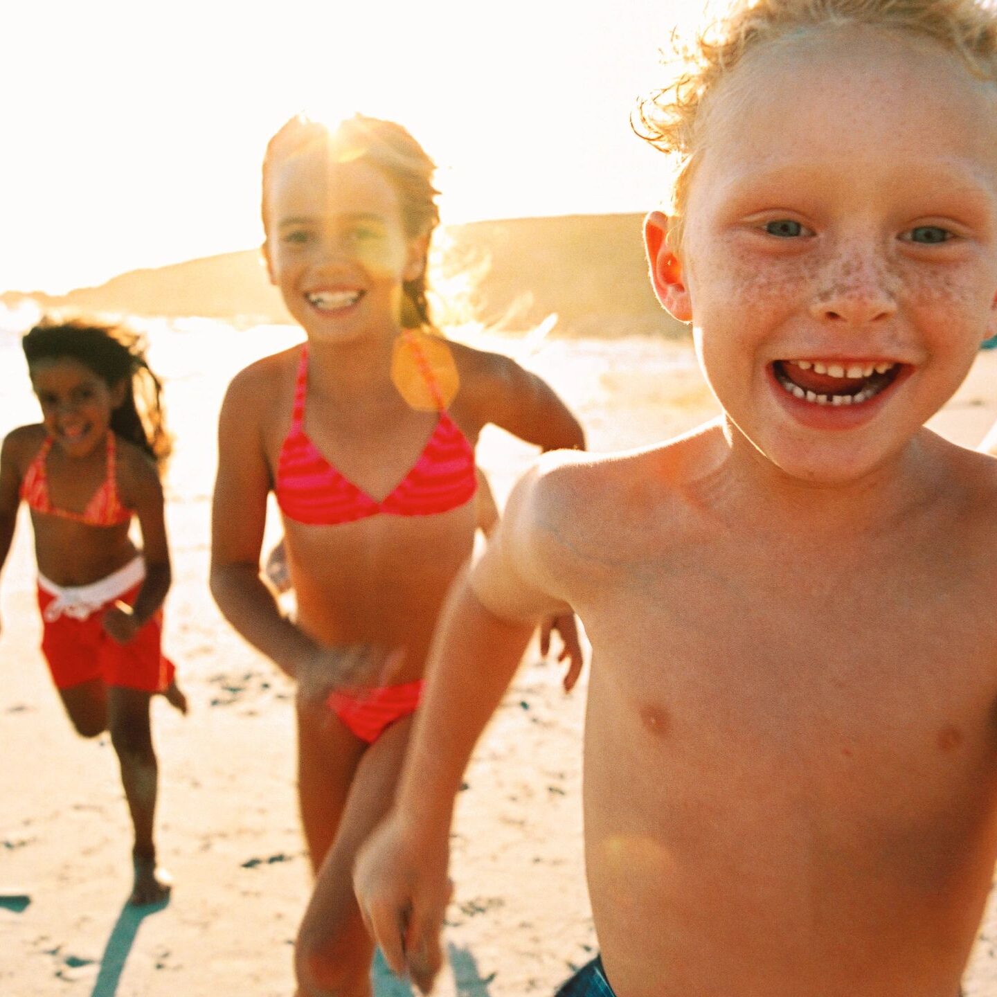 A group of kids playing on the beach